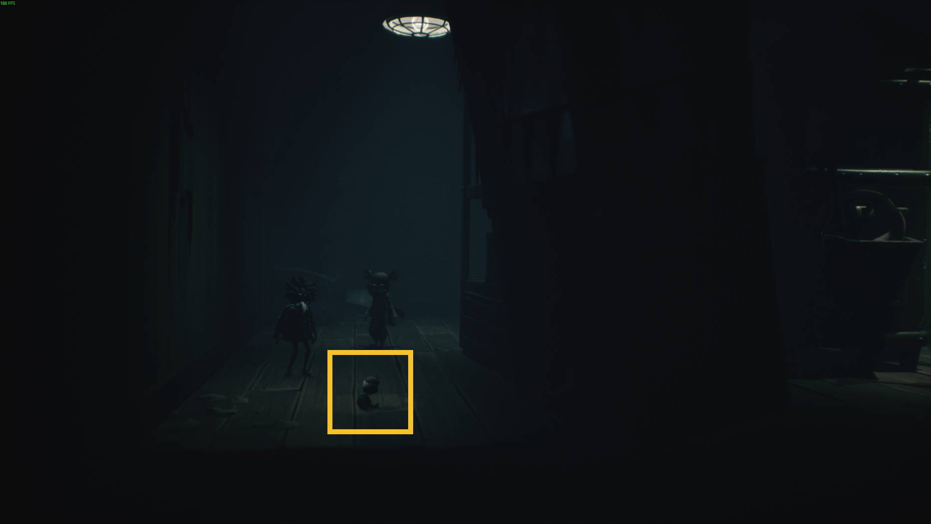 A doll-like figure stands on the wooden floor under a ceiling light, with two child characters nearby in Little Nightmares 3.