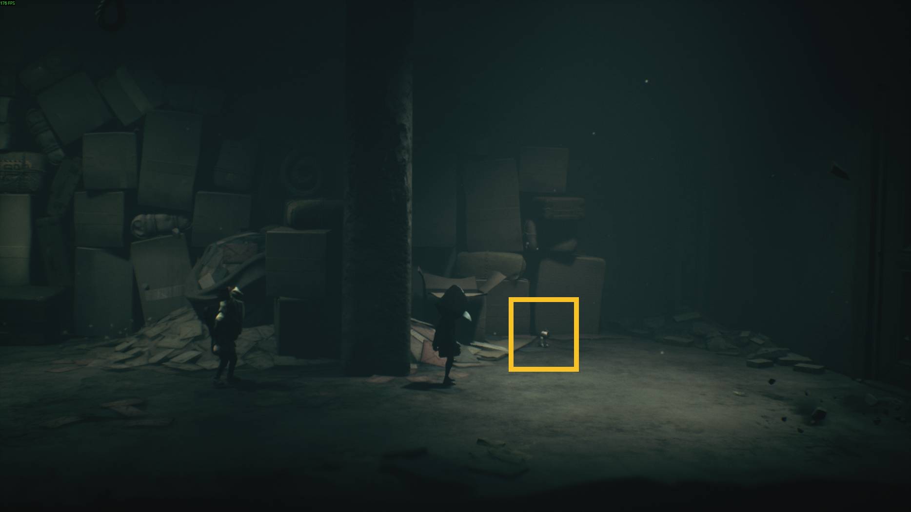 Small hidden figure standing among scattered boxes in the storage room of Little Nightmares 3