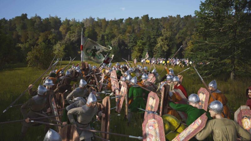 Medieval Manor Lords battle reenactment with participants in armor and period costumes holding lances and shields in an outdoor setting.