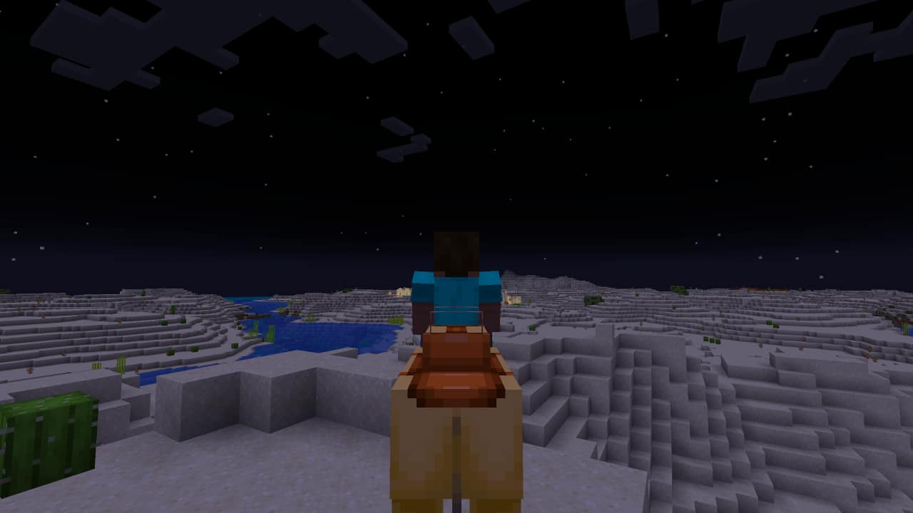 Minecraft camels guide: A lone player rides a camel through the nighttime desert.