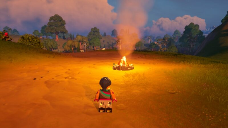 Character looks at a campfire in LEGO Fortnite.