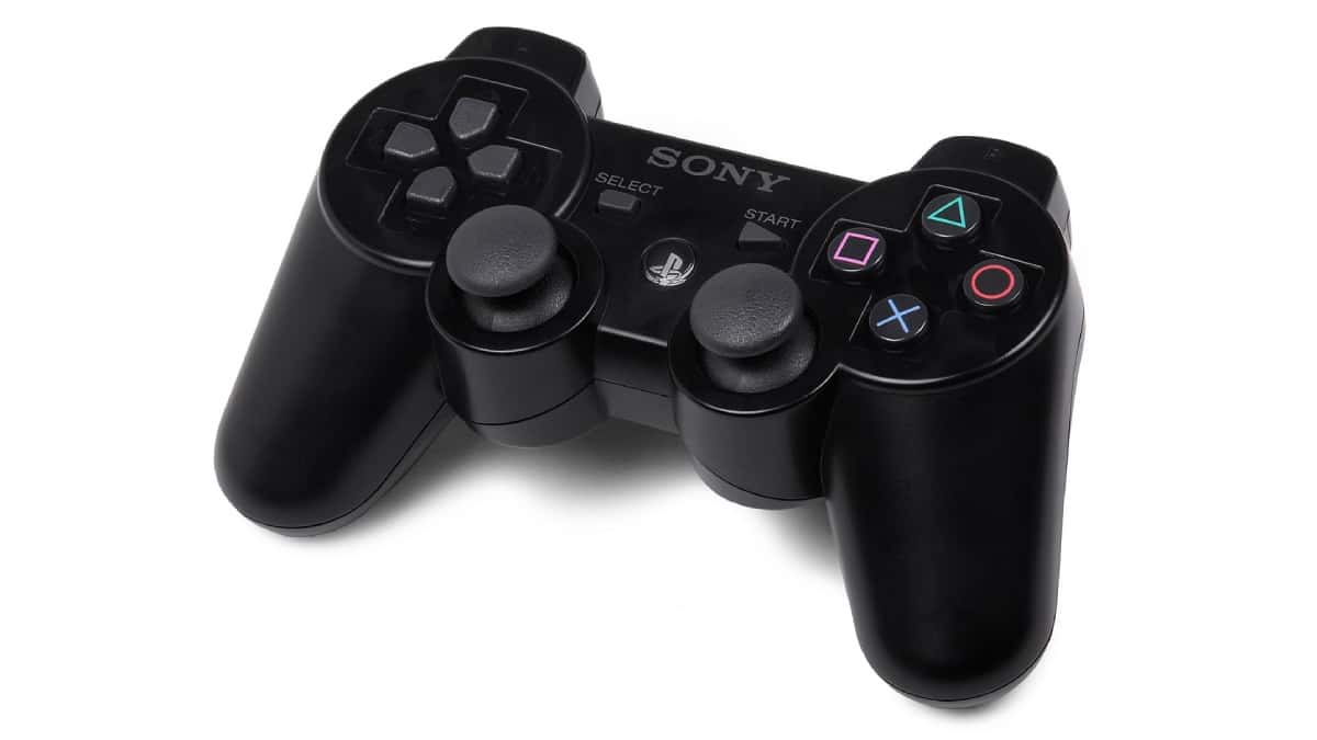 A black Sony PS3 controller displayed on a white background, highlighting the evolution of PlayStation controllers since 1994.