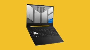 A laptop with a keyboard on a yellow background.
