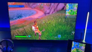 A Samsung Odyssey G8 tv screen displaying a Fortnite game.