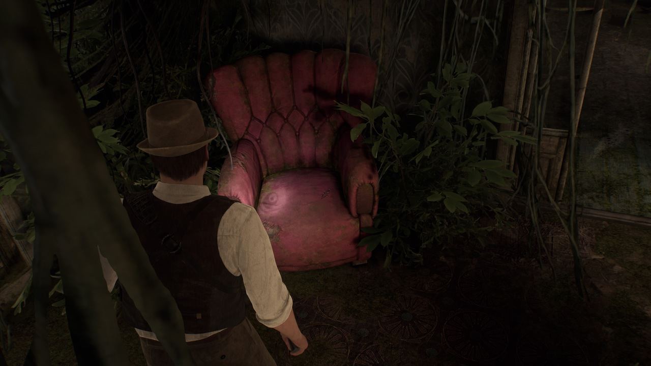Man in vintage clothing standing alone in front of an old, worn-out armchair in a forest setting.
