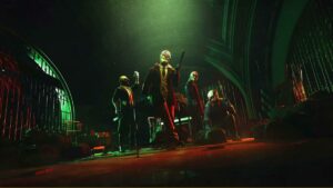 A group of people in a dark room planning heists for Payday 3.