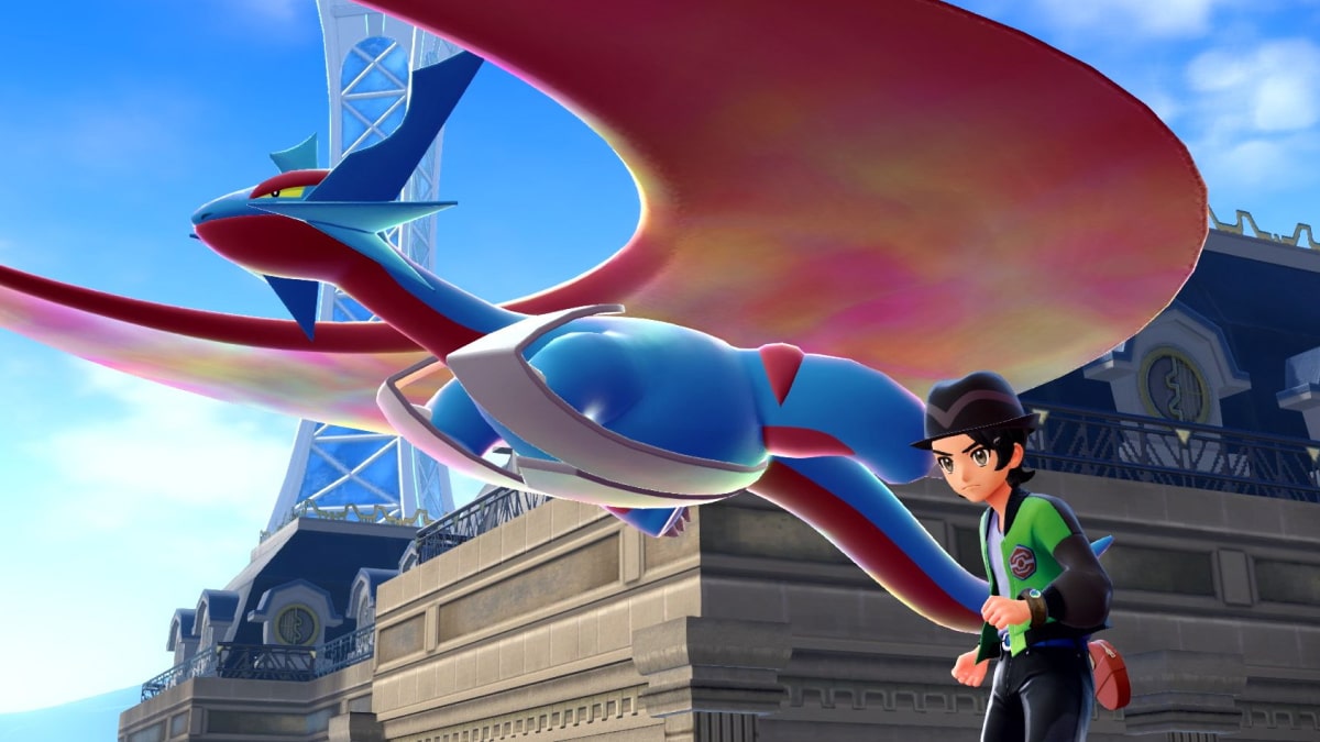 A Pokémon Trainer stands beneath Mega Salamence soaring through the skies of Lumiose City in Pokémon Legends Z-A.
