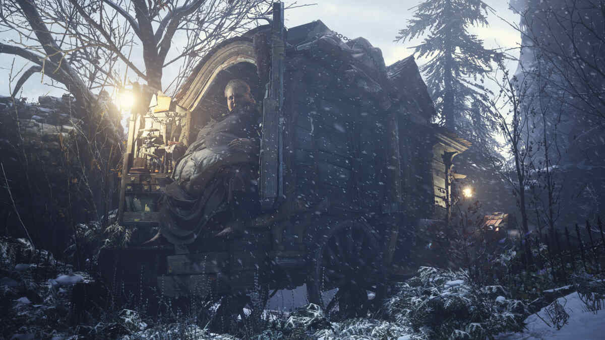 Man sitting in a wooden, gypsy-style caravan surrounded by trees in Resident Evil Village.