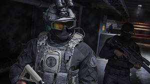 A man in a military uniform is holding a gun at the MW3 reveal event.
