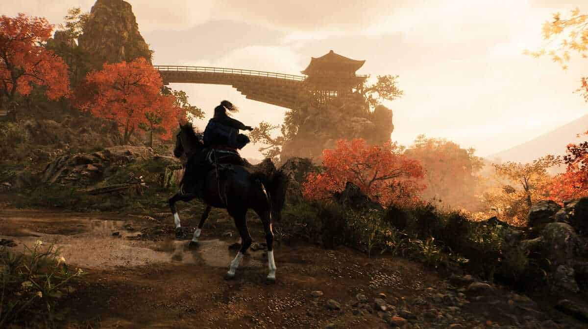 A person on horseback rides through a scenic area in Rise of the Ronin