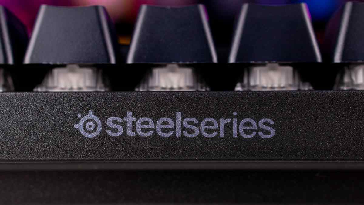 A close up of the Steelseries logo on a black keyboard.