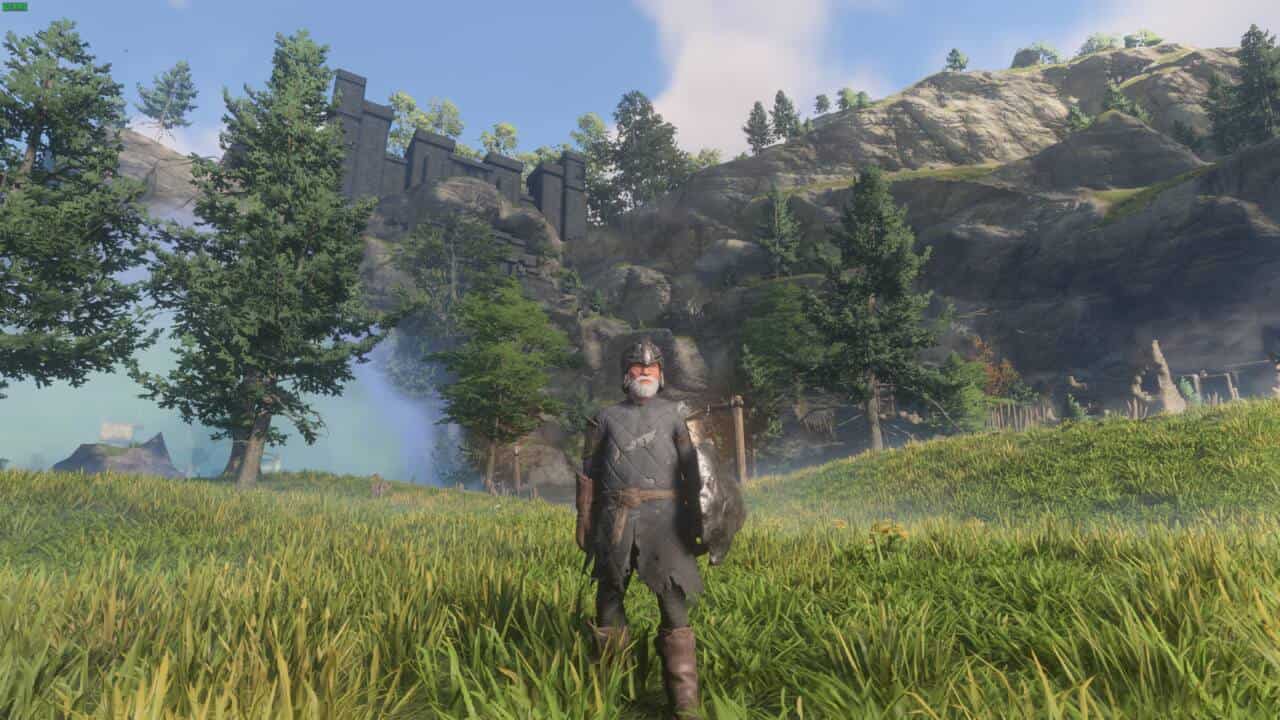 Enshrouded Crucible: character in a grassy field with mountains in the background.