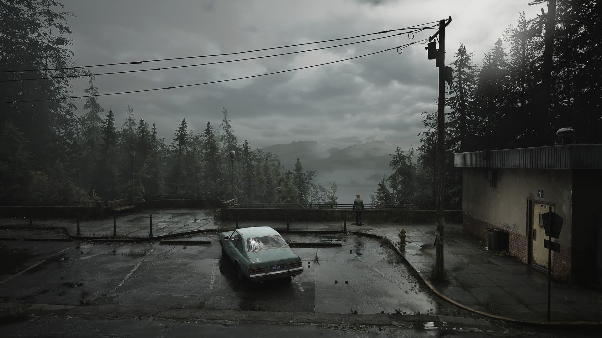 Foggy parking lot and lake view scene from the Silent Hill remake showcasing the game's eerie environment