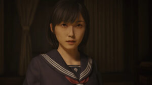 A close-up of the main female character in Silent Hill 2 wearing a navy school uniform, standing in a dimly lit room with a serious expression.