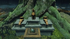Three fox statues at the base of a large tree in the Ghost of Yotei Poison and Snow quest, marking the start of the lantern puzzle