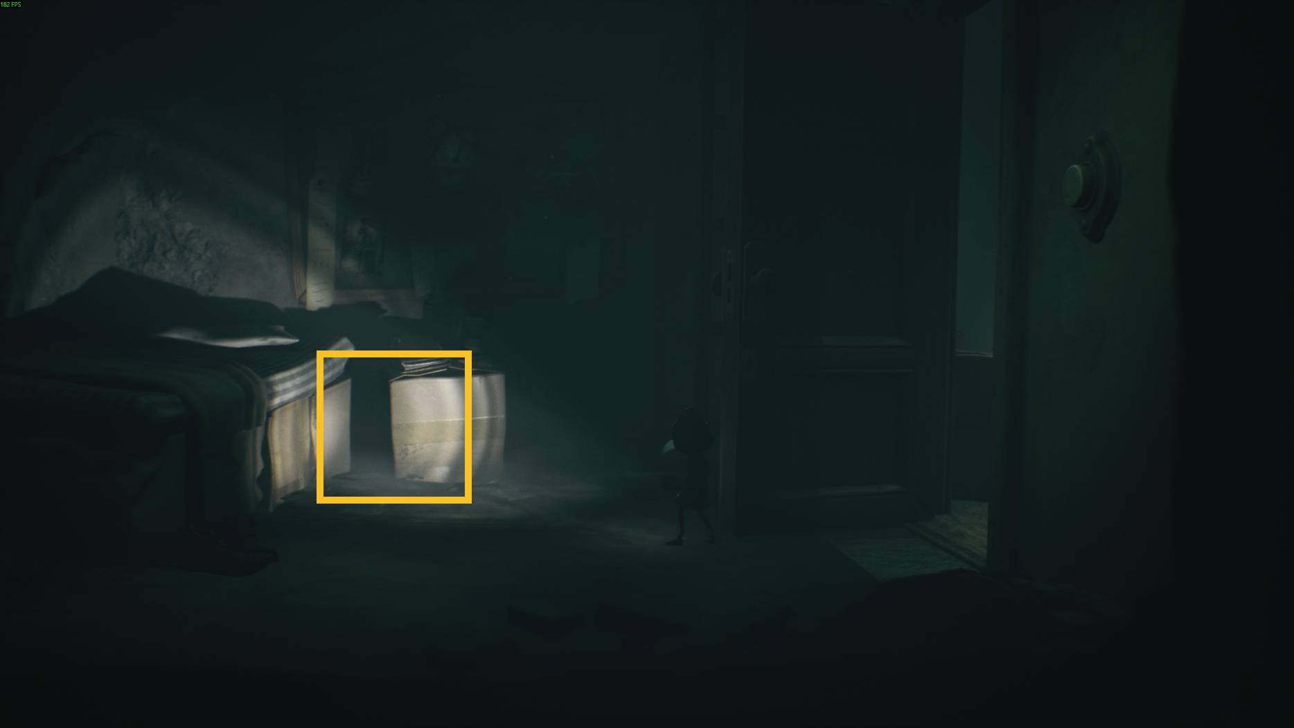 A child hat points a flashlight under a bed to reveal a hidden ghost in All Little Nightmares 3.