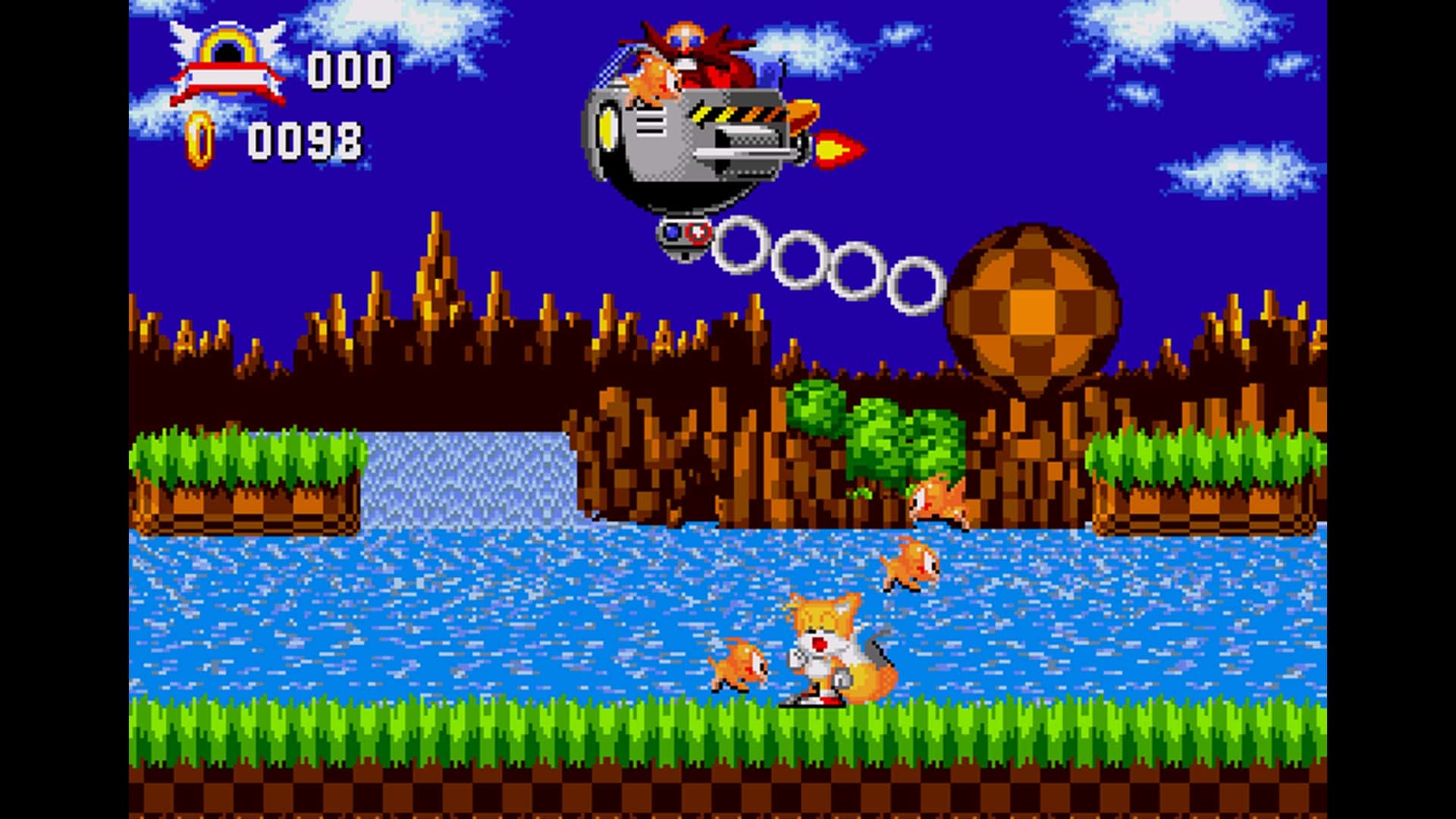 Tails faces Dr. Eggman in a classic boss fight over water during Sonic Hacking Contest 2025, with bright blue skies and pixelated green platforms.