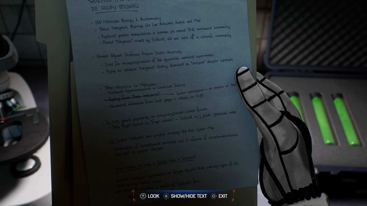 A hand holding a piece of paper with Spider-Man 2 easter eggs in front of a computer.