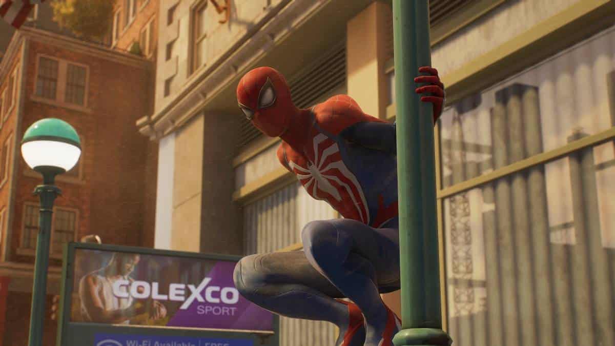 A Spider-Man is hanging from a lamp post in Marvel's Spider-Man 2.