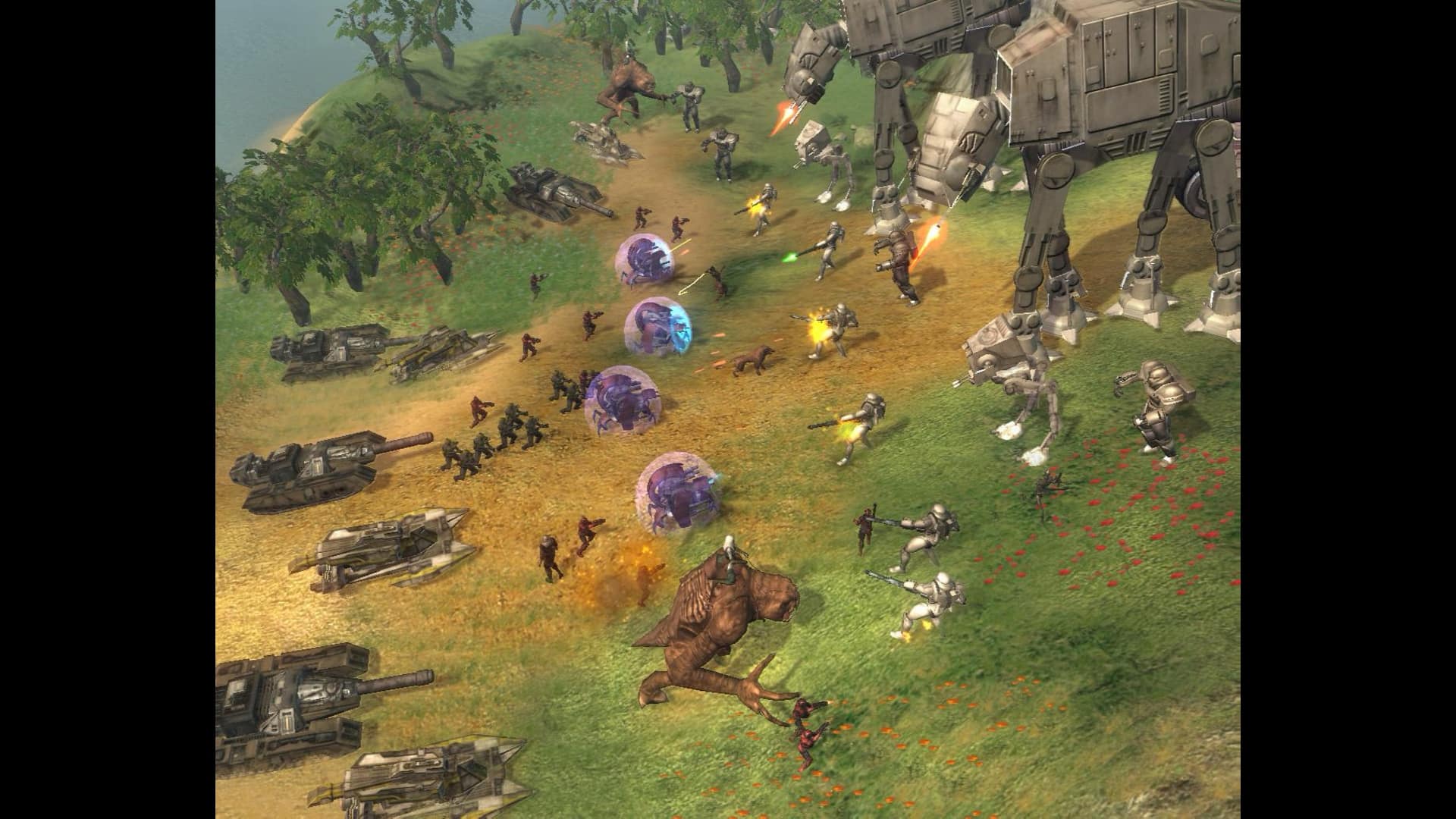 A grassy battlefield filled with futuristic vehicles, soldiers, and large robotic walkers exchanging laser fire in Star Wars: Empire at War