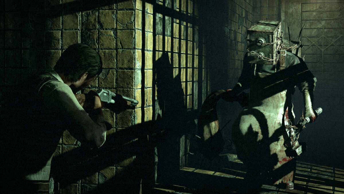 A man aims a shotgun at a monstrous figure wearing a metal box over its head in The Evil Within.