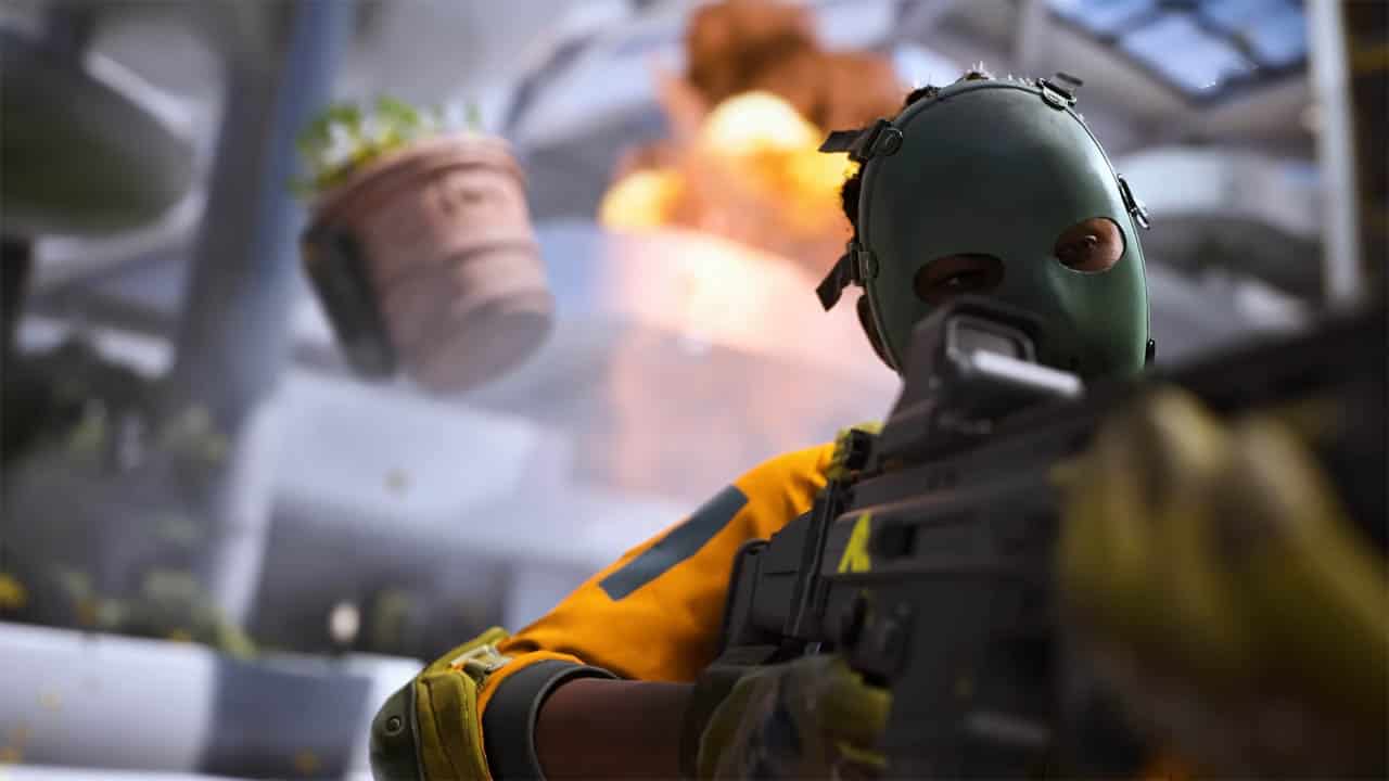 During The Finals, a man in a green mask is holding a gun.