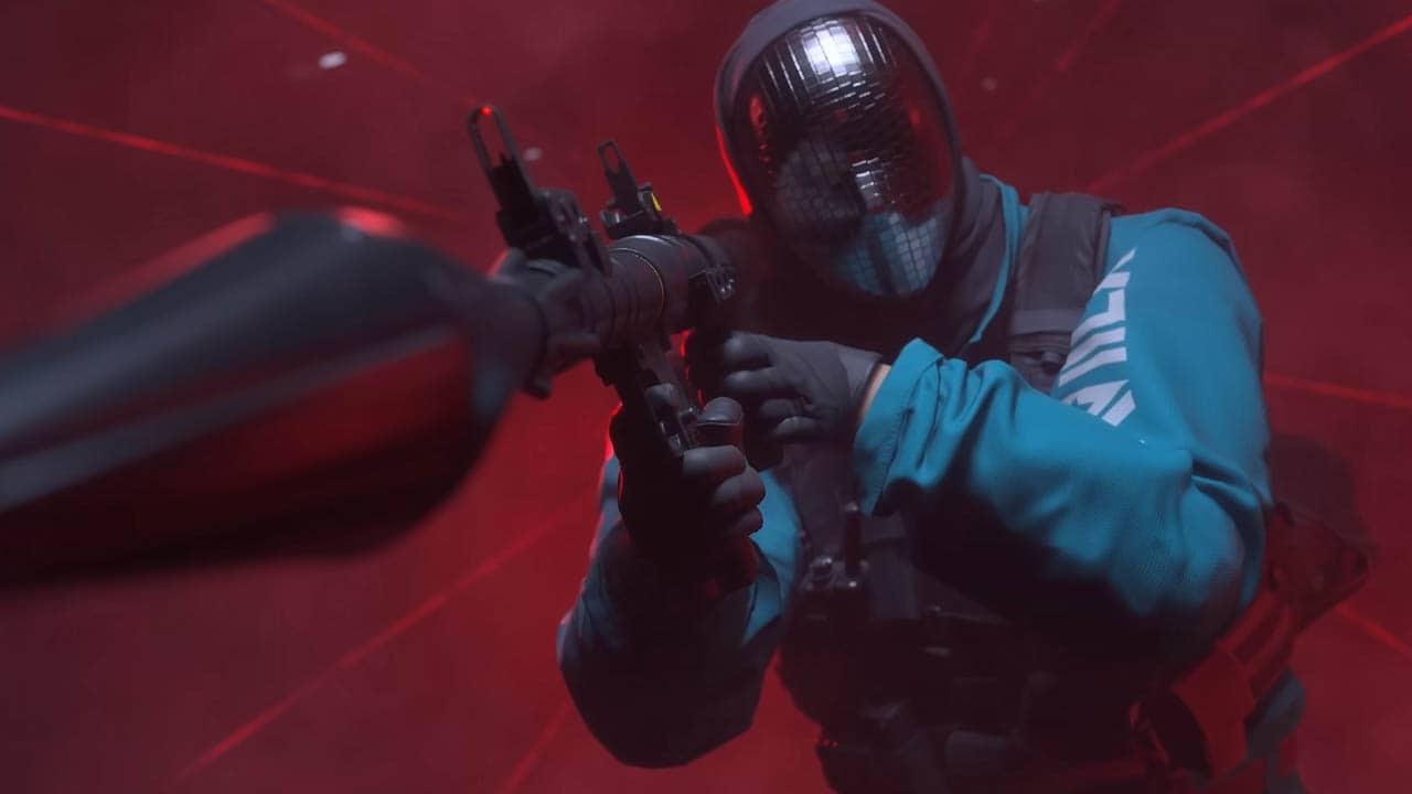 A man holding a gun in front of a red light at the finals twitch drops.