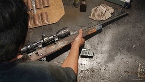 The Last of Us Part 1 a gun on a workbench, as it's upgraded by Joel