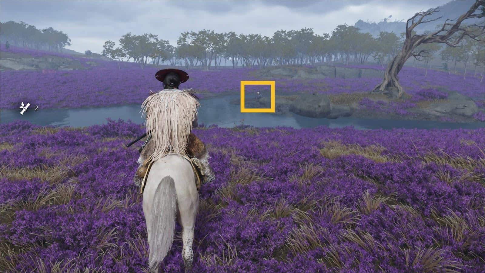 A rider on a white horse, dressed in a feathered cloak, surveys a serene purple flower field beside a lake in Ghost of Yotei