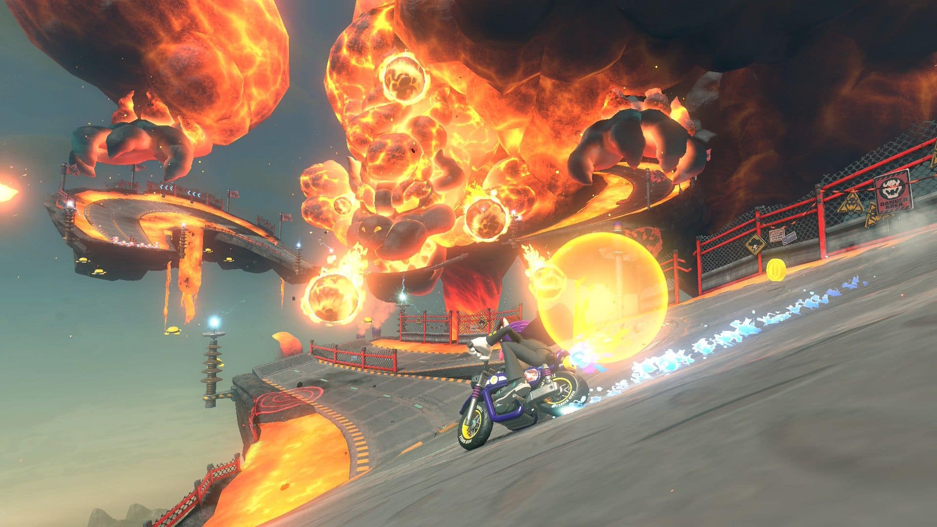 Rider speeds through a fiery volcanic track in Mario Kart World surrounded by explosions