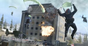 Paratroopers in action amidst an explosion from a building with a helicopter and jet in the background of a warzone.