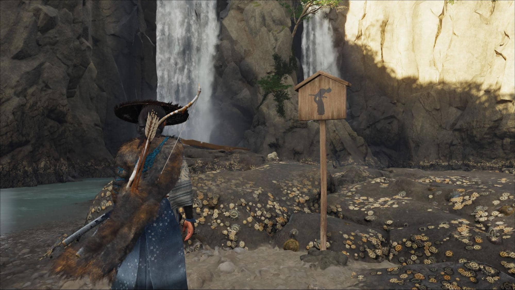 Samurai near bowing sign by waterfall in Ghost of Yotei