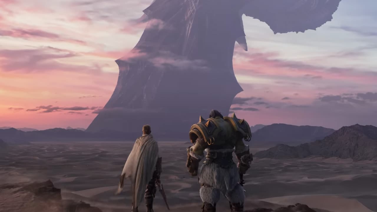 Two people standing in front of a giant sword in World of Warcraft.