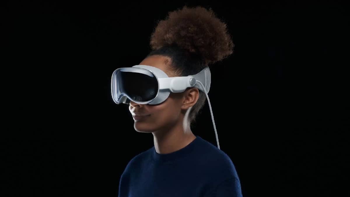 A woman wearing VR goggles on a black background, exploring the immersive world.