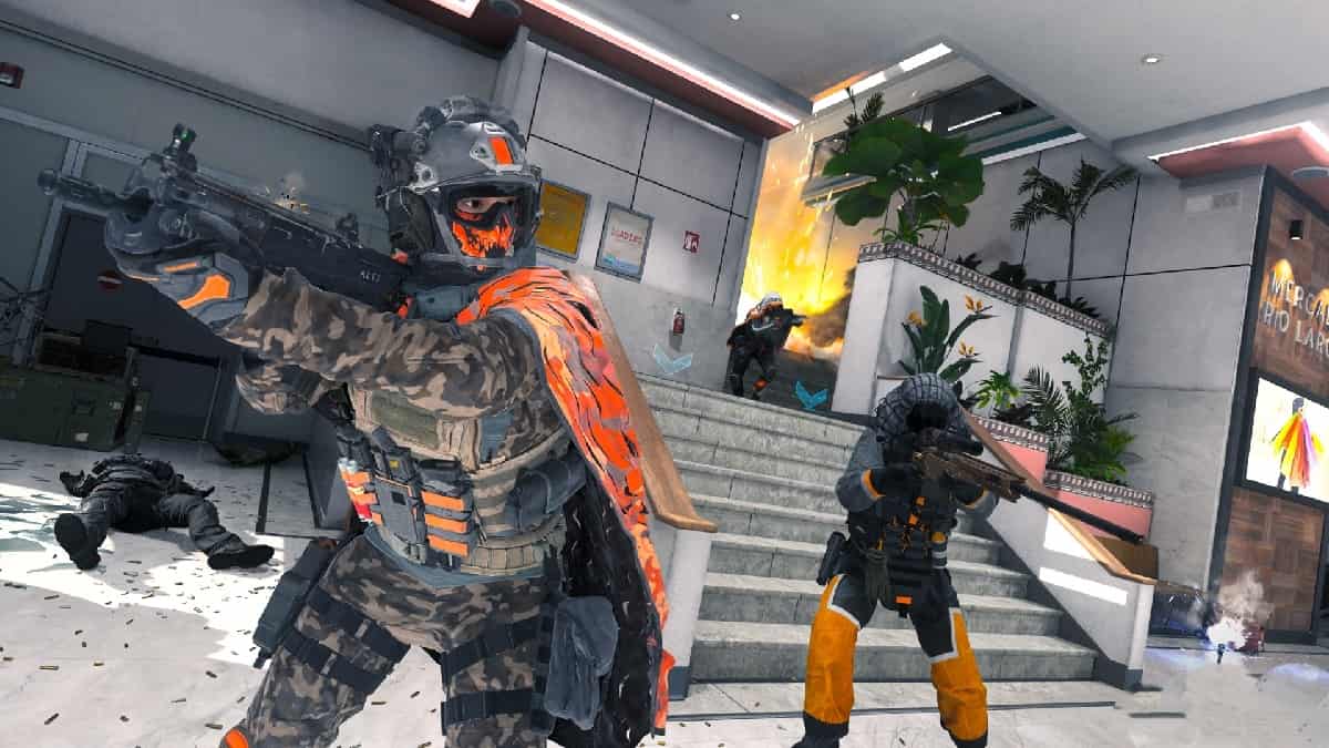 A group of soldiers armed with MW2 guns are standing in front of a building.