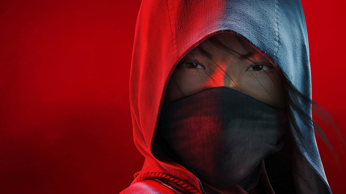 Close-up image of Naoe from Assassin's Shadows wearing a hood and mask, against a red background.