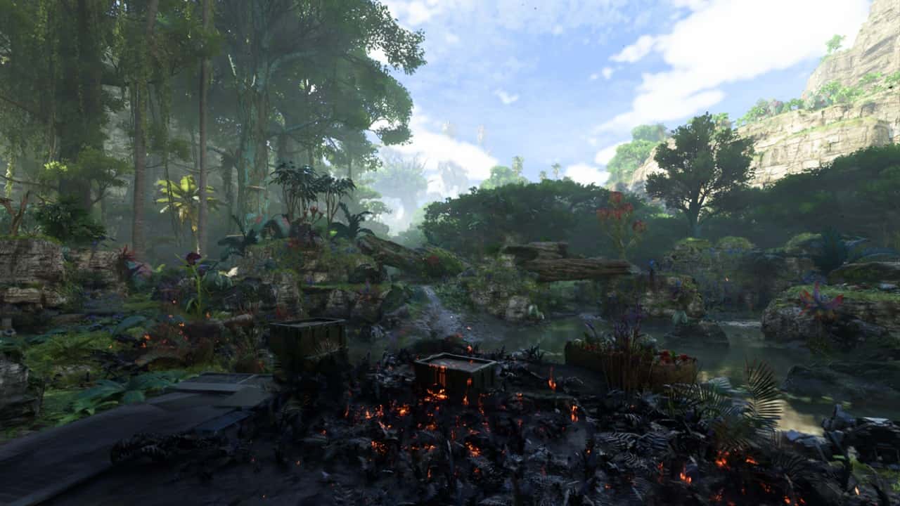 A screenshot of a jungle with trees engulfed in flames in Avatar: Frontiers of Pandora. Image captured by VideoGamer.