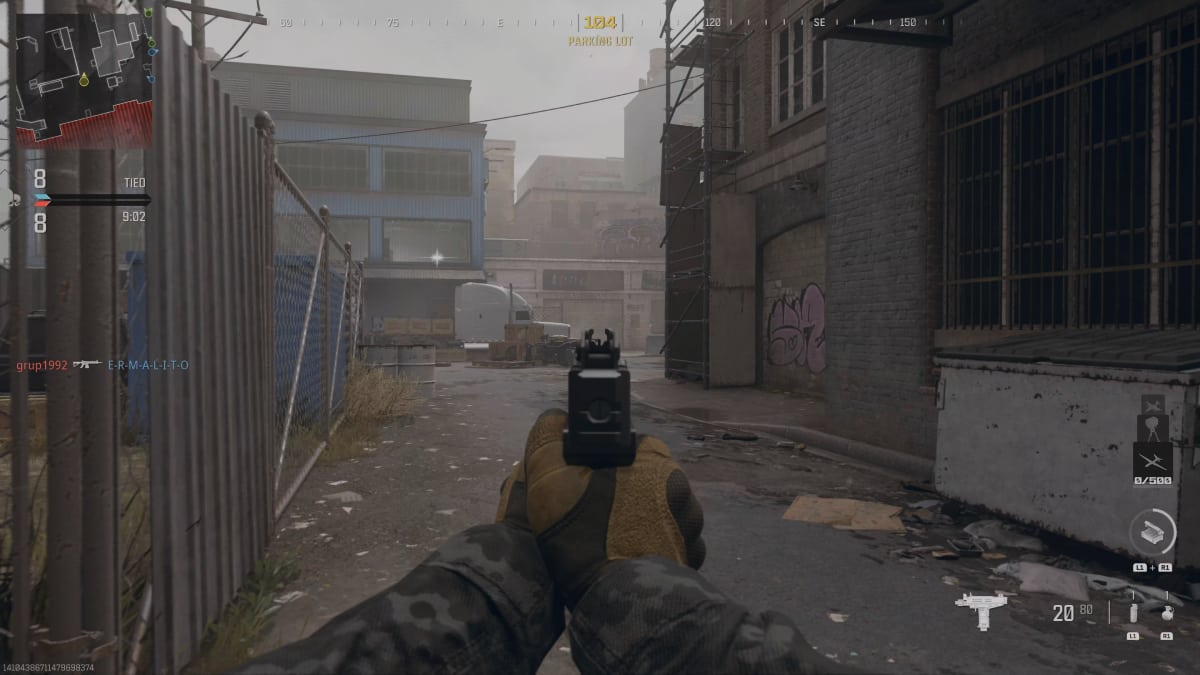A screenshot of a video game showing a gun in a street, featuring the best WSP Stinger loadout in MW3.