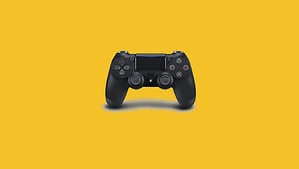 A black PS5 controller on a yellow background.