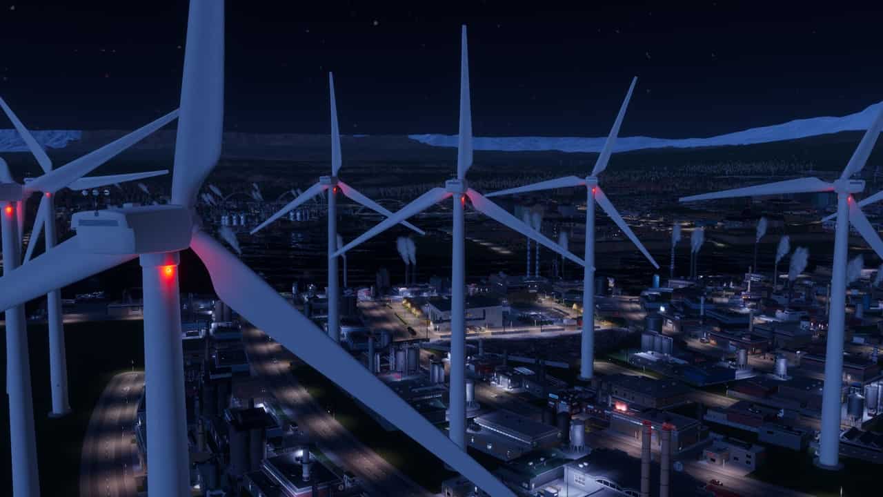 Cities Skylines 2 beginners: An image of wind turbines at night.