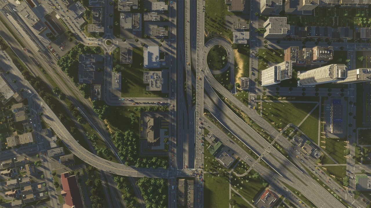 Cities Skylines 2 early access: An aerial view of a bustling city with a sprawling network of highways.
