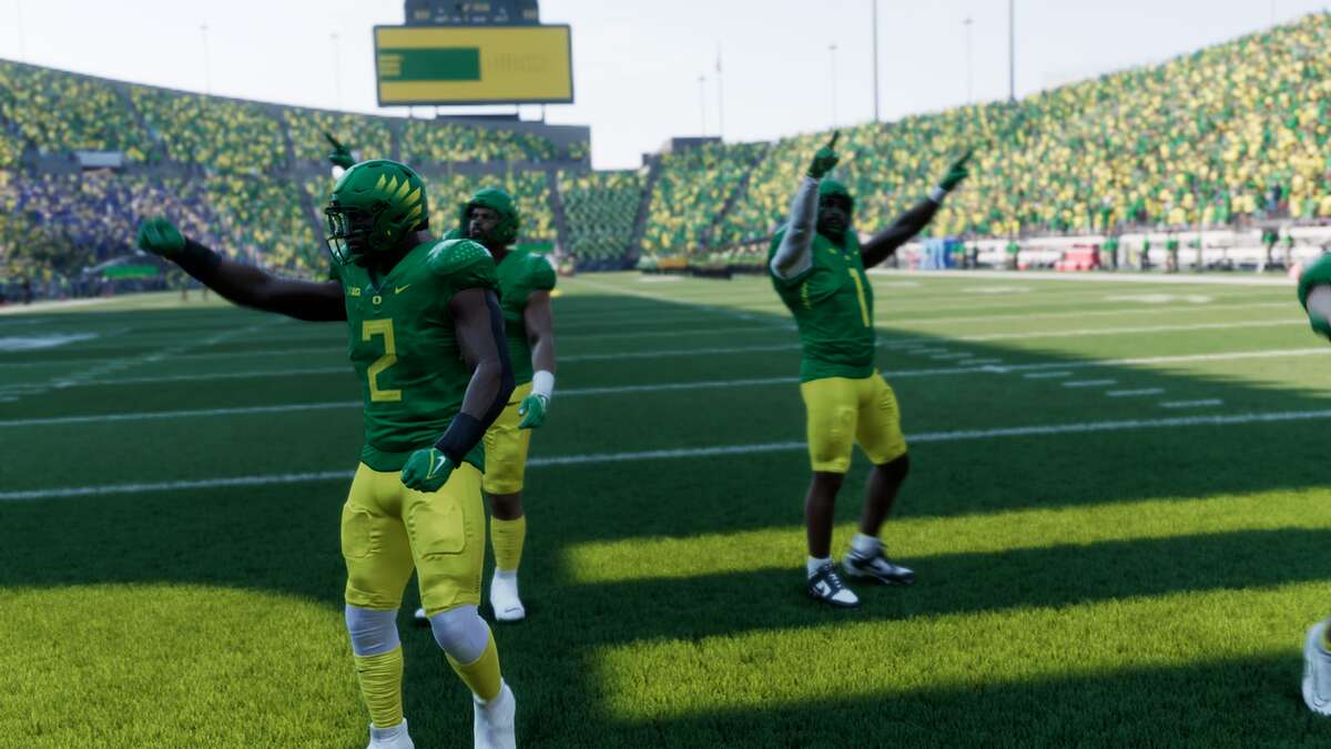 All College Football 25 teams: Three football players in green jerseys and yellow shorts waving to a home crowd.