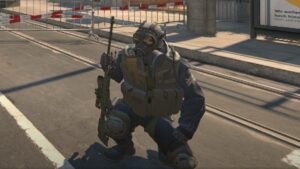 A man in a gas mask is standing on a street.