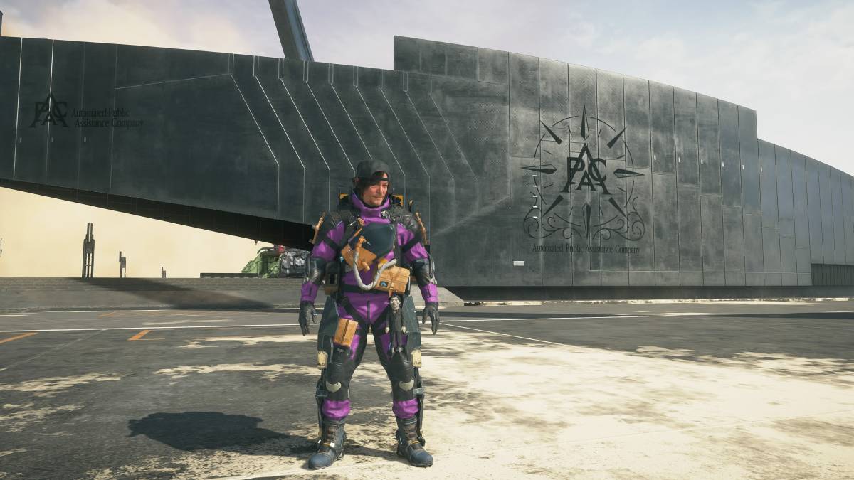 Death Stranding 2 change suit color: Sam outside a facility wearing the purple suit color scheme.