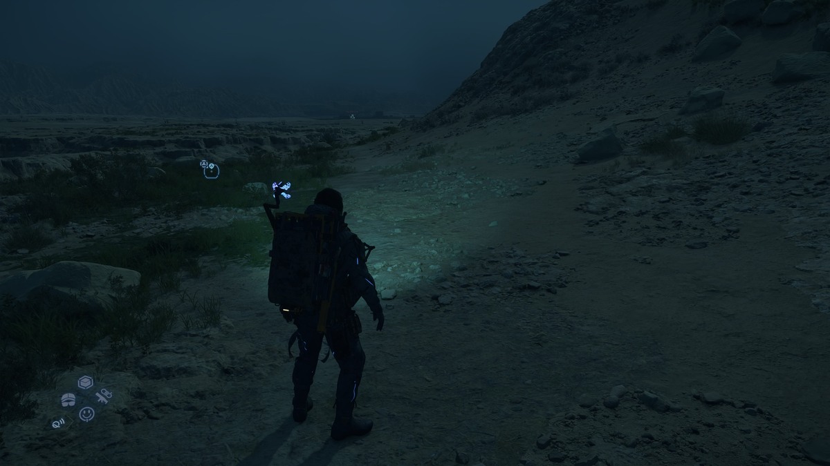 Death Stranding 2 Odradek Light: Sam in the desert using the Odradek Light.