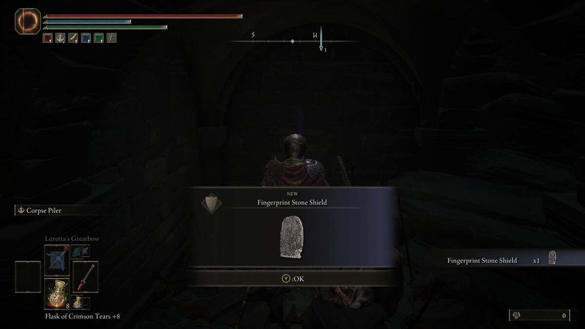 Elden Ring Fingerprint Stone Shield: A player picking up the Fingerprint Stone Shield.