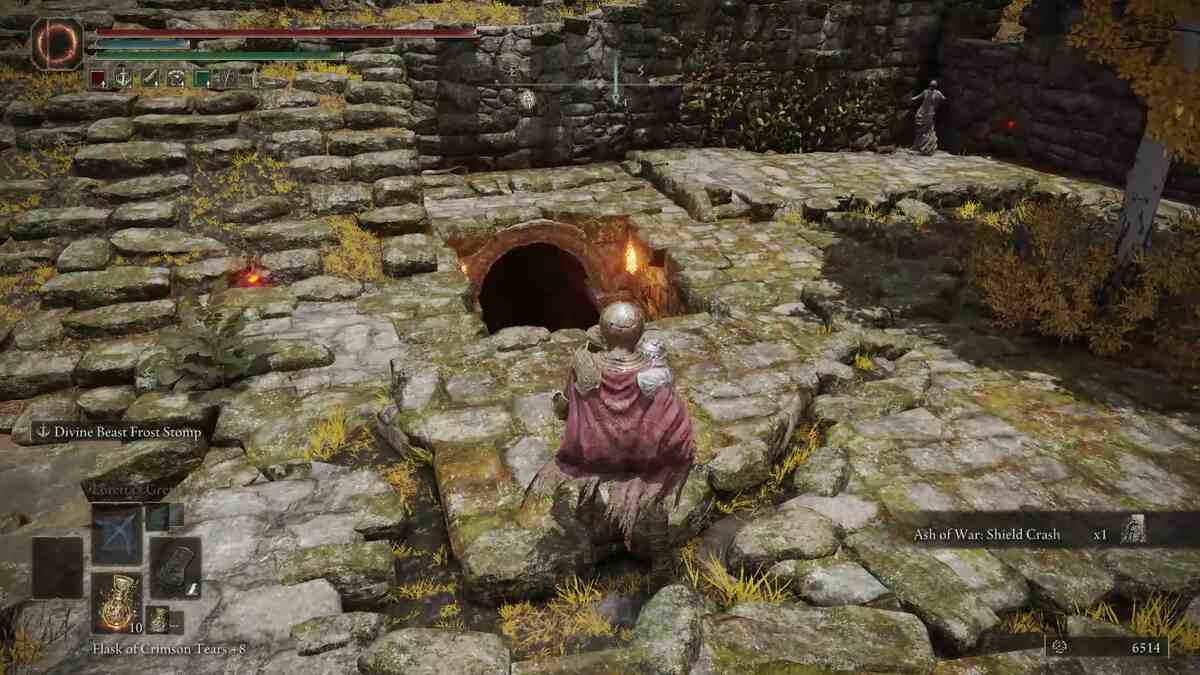 Elden Ring Ritual Sword Talisman: A set of stairs leading down to an archway lit by torches.