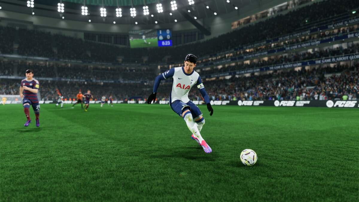 FC 25 FUT Champs rewards: Son Heung-min dribbling a ball for Tottenham during a match at night.