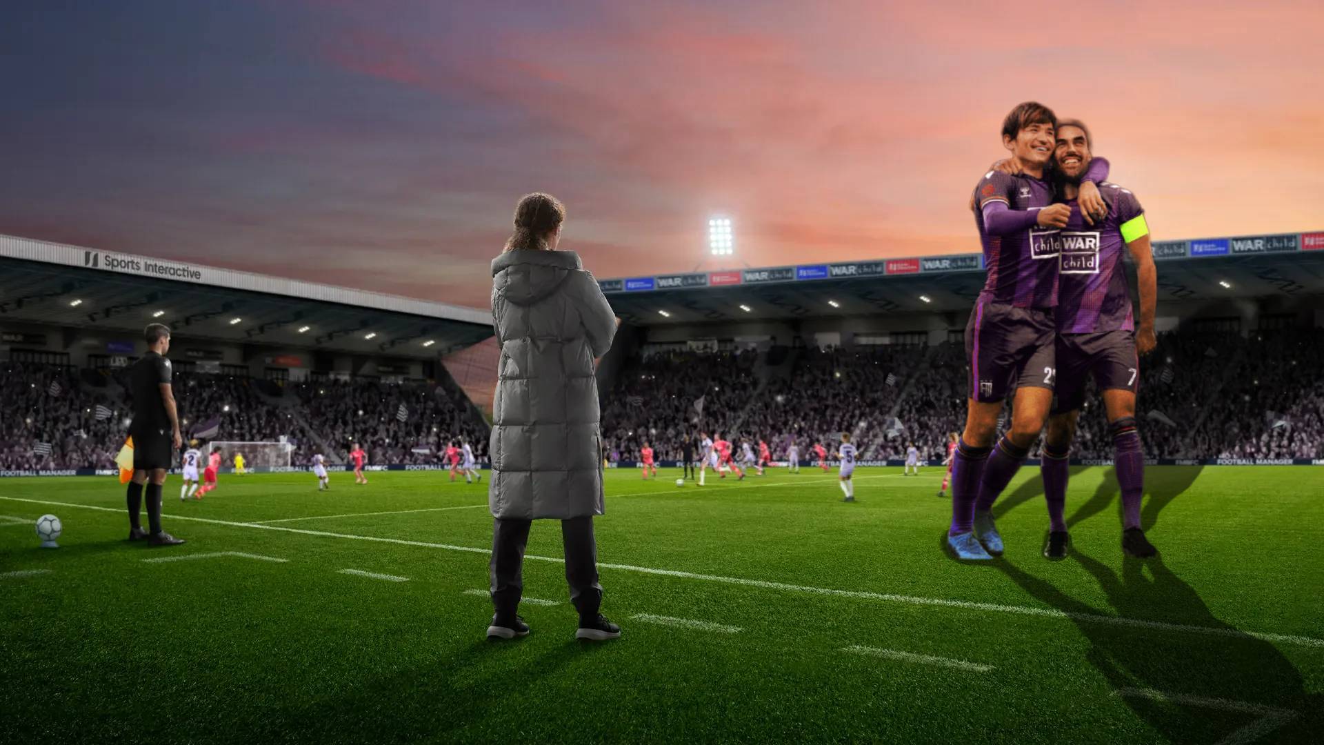 Two giant Football players standing next to a Football Manager