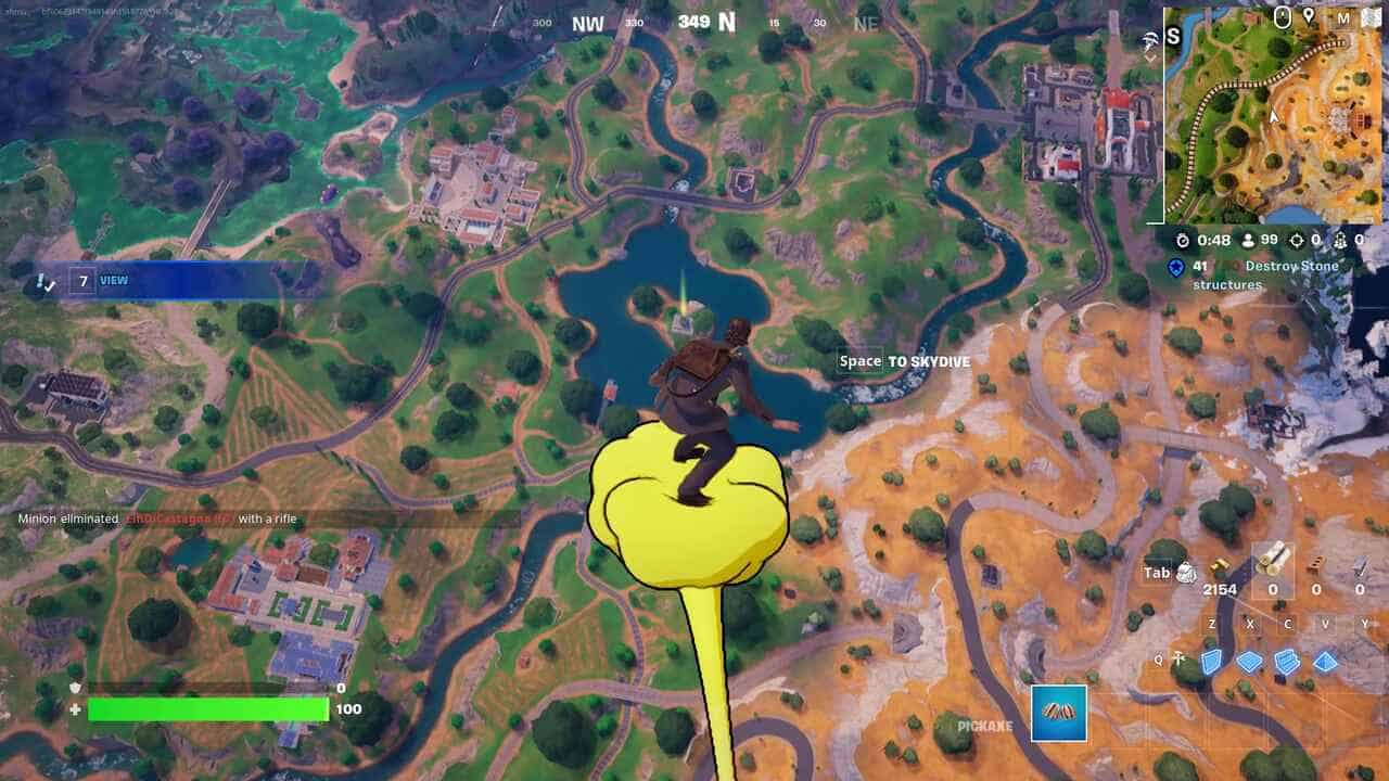 Fortnite best hiding spots: A player gliding on a yellow cloud high above the Fortnite map.